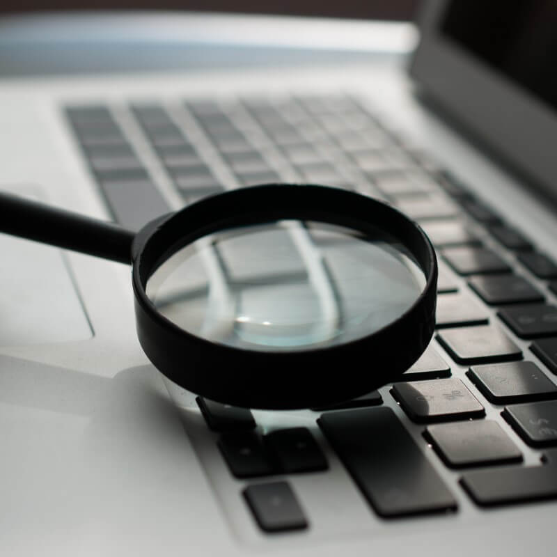 Website audits - magnifying glass on keyboard
