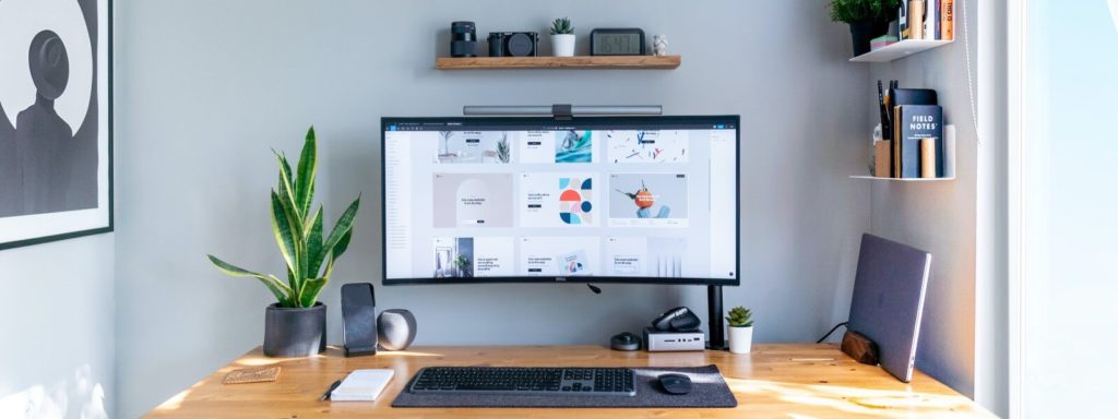 Signs you need a new website - Desk with computer designs
